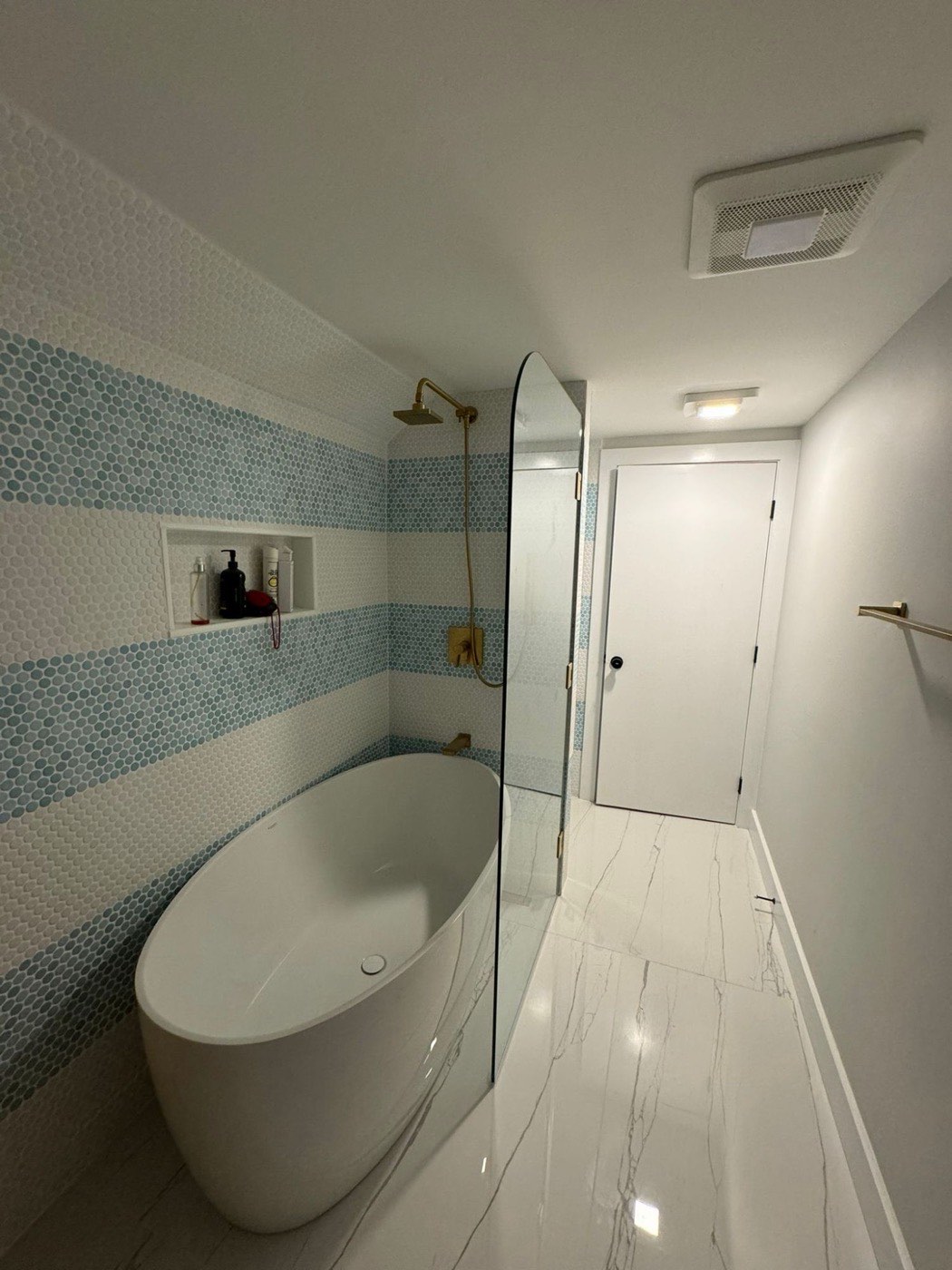 Bathroom remodel with freestanding tub and penny tile